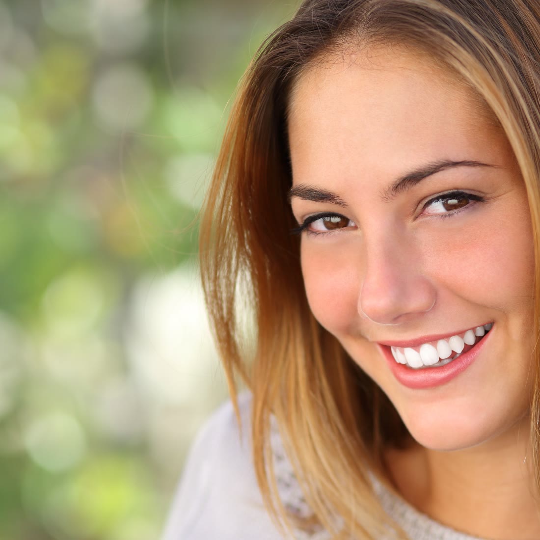 A young woman smiling at the camera